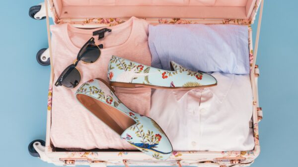 clothing items and pair of shoes in luggage