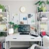 turned on flat screen monitor white wooden desk