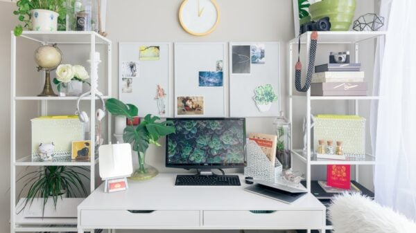 turned on flat screen monitor white wooden desk